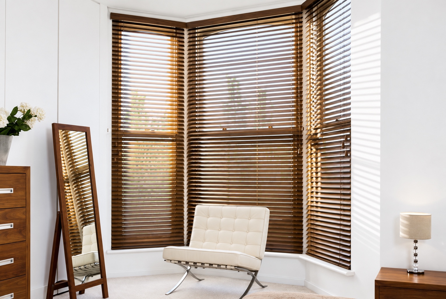 Walnut wooden Venetian blinds fitted around a bright bay window