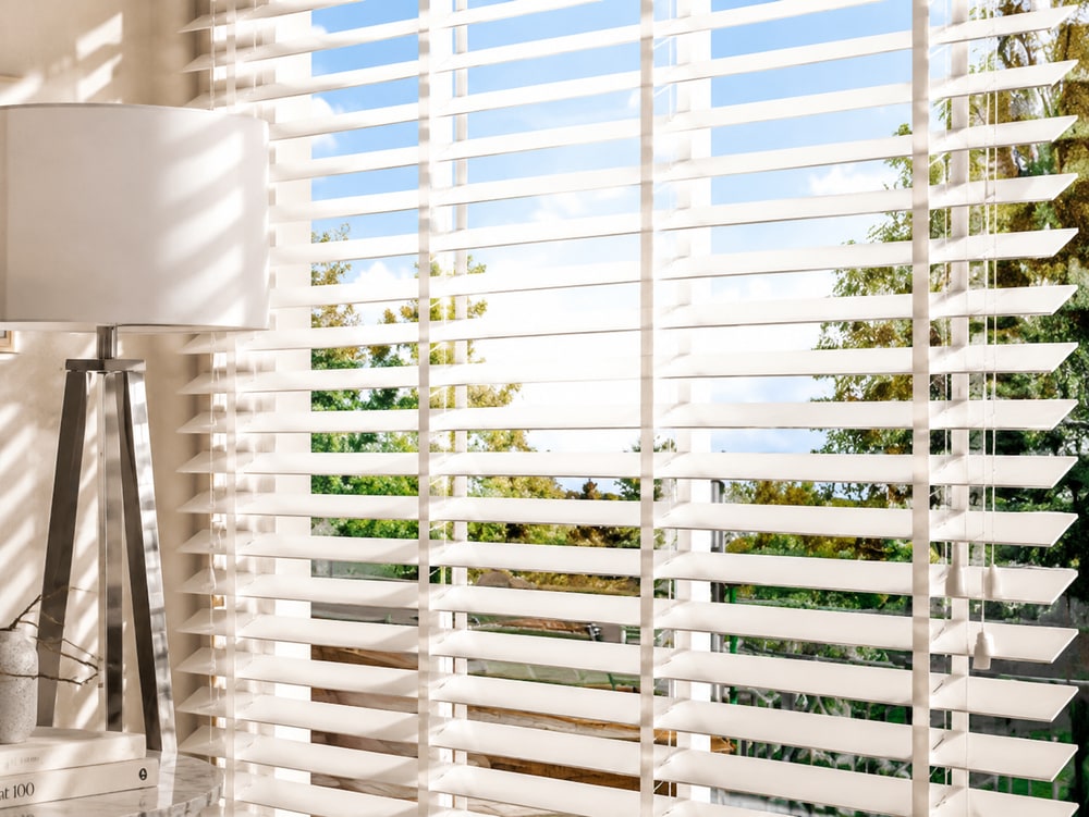 White pure wood Venetian blinds fitted in a bright room