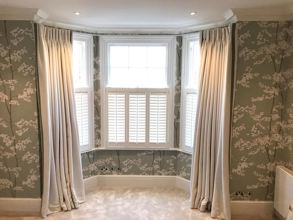 Made-to-measure shutters fitted around a bay window