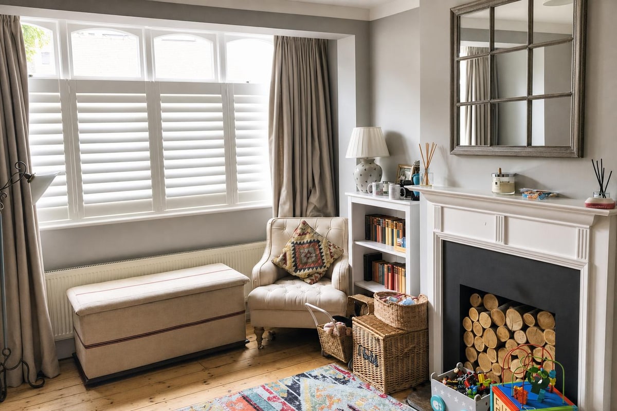 Café Style shutters fitted below the windows in a bright living room