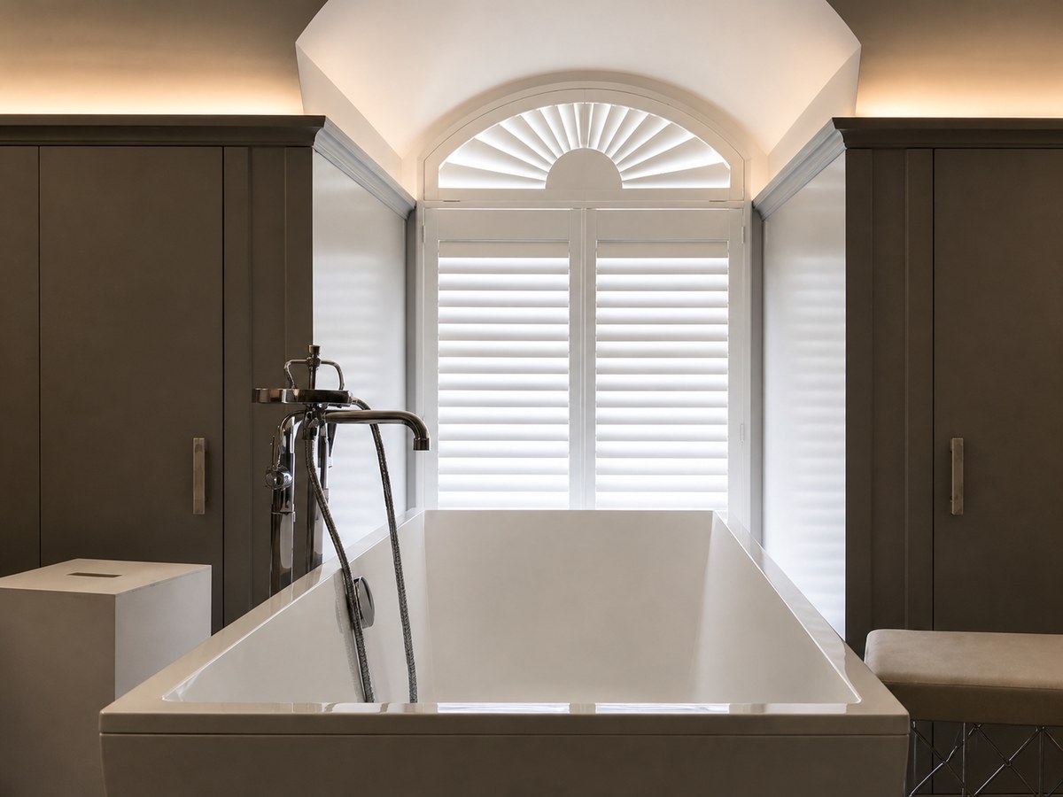 Arched shutters in a dark, elegant bathroom