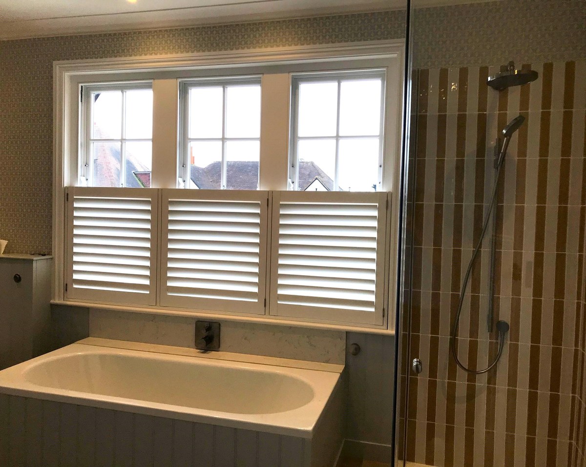 Waterproof Café Style shutters fitted above a bath in a bathroom