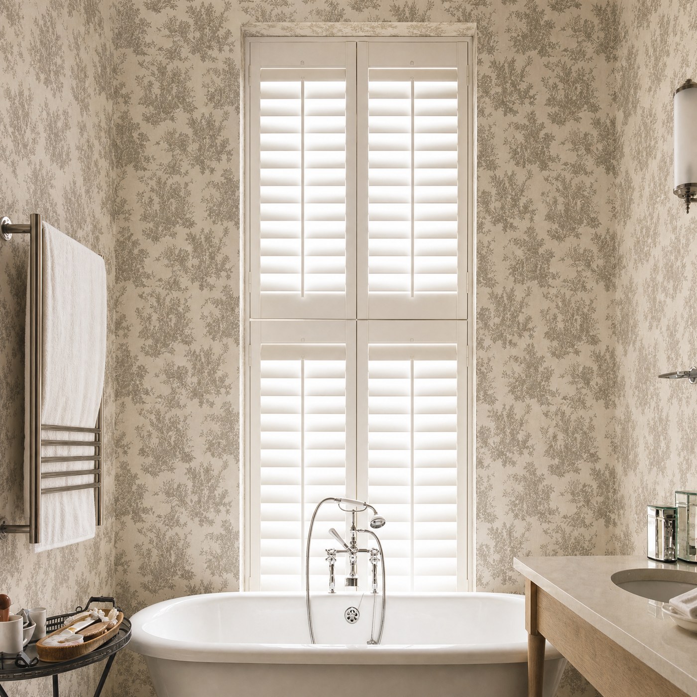 Waterproof white shutters fitted beside a bath in a bright bathroom