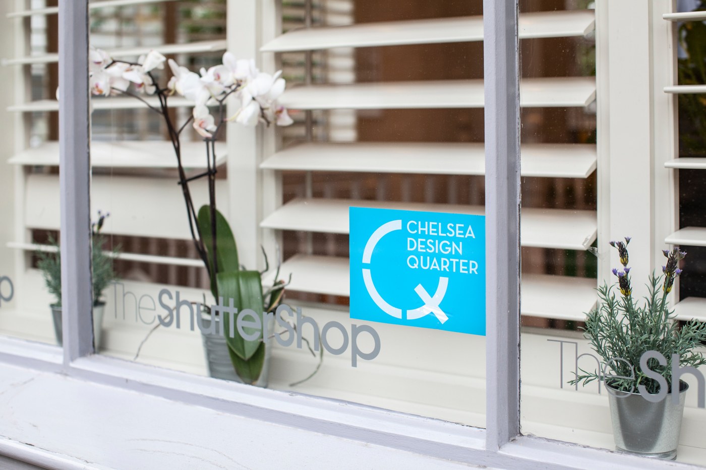 The Shutter Shop Fulham showroom window displaying the Chelsea Design Quarter sign