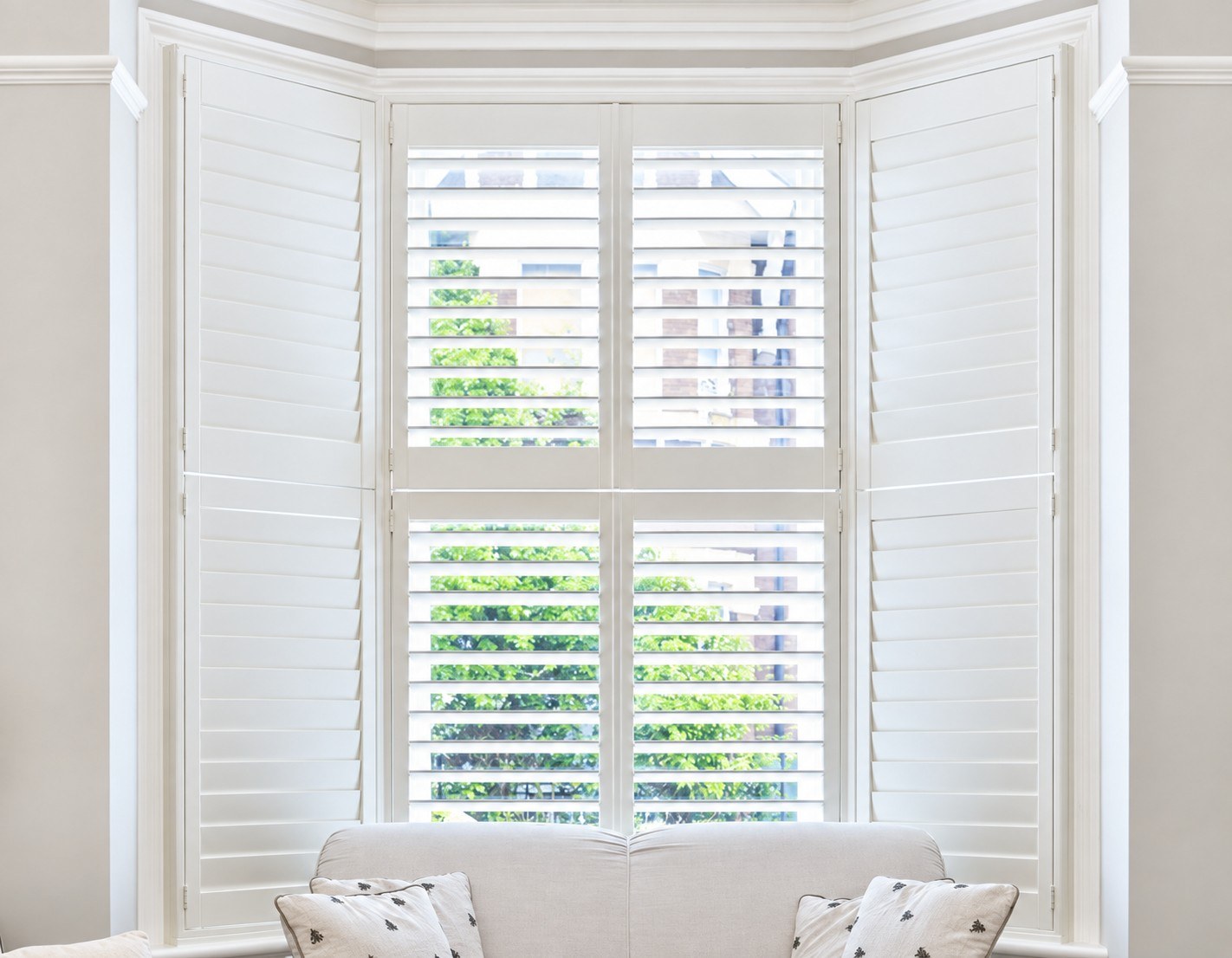 White tier-on-tier shutters in a living room bay window