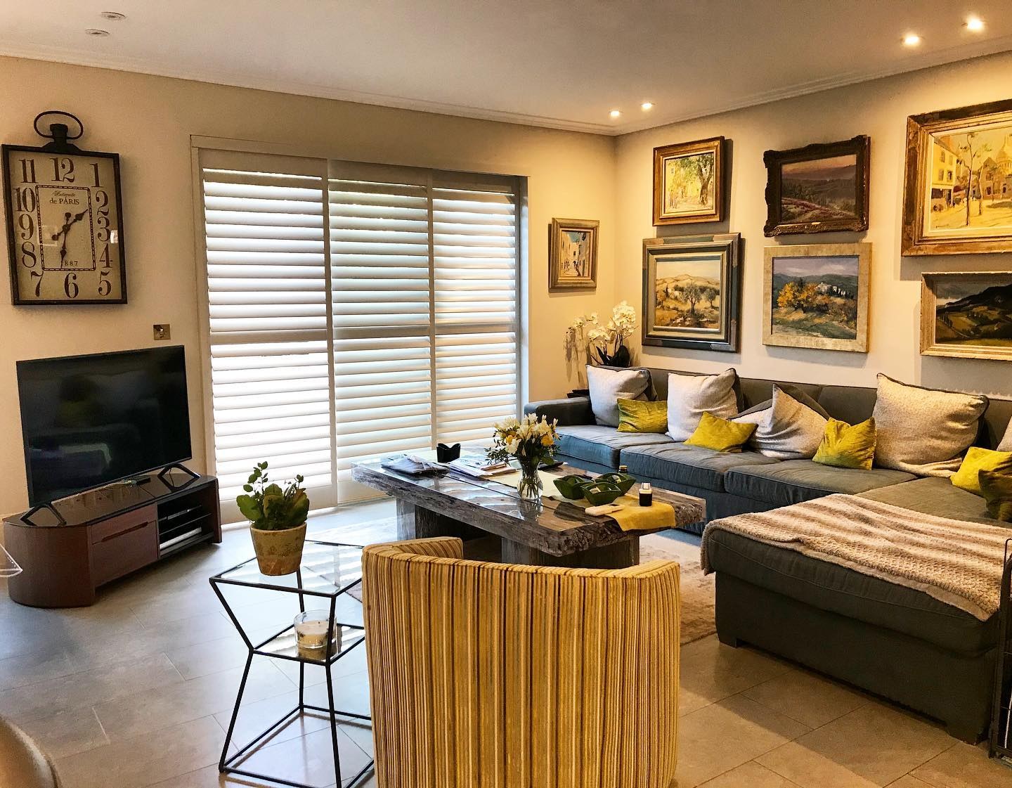 Sliding shutters fitted across a wide living-room opening