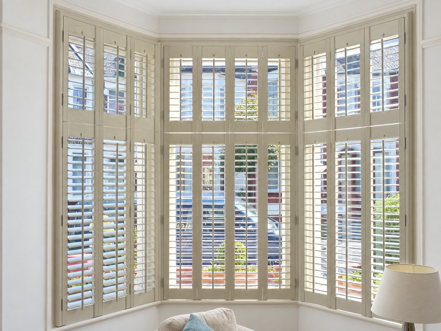 Tier-on-tier shutters across a period bay window