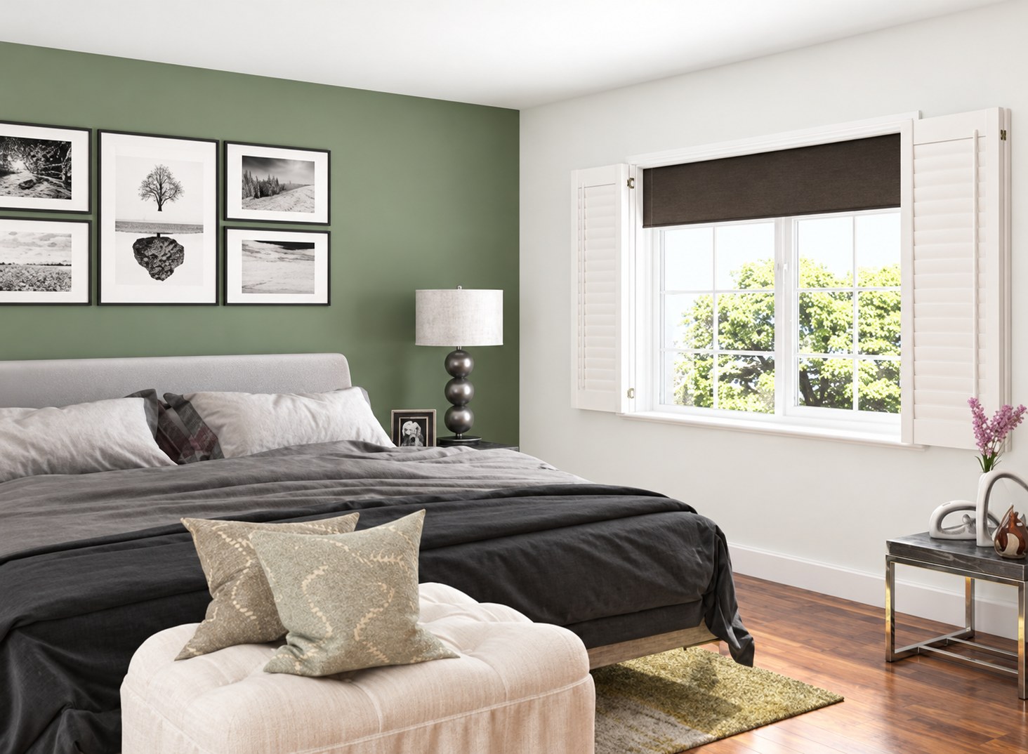 Room darkening blind lowered behind white plantation shutters in a calm bedroom