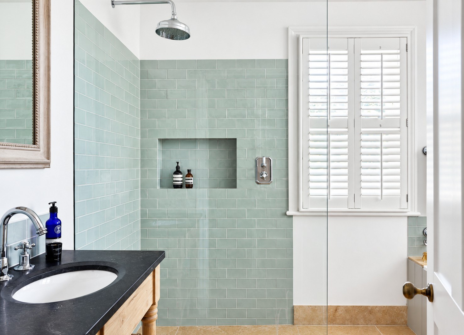 Tier-on-tier shutters in a bathroom with a shower