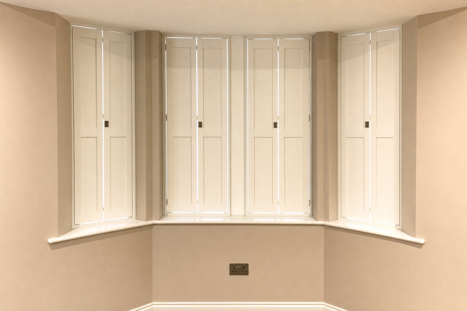 Solid Shaker shutters fitted to a bay window in Thames Ditton