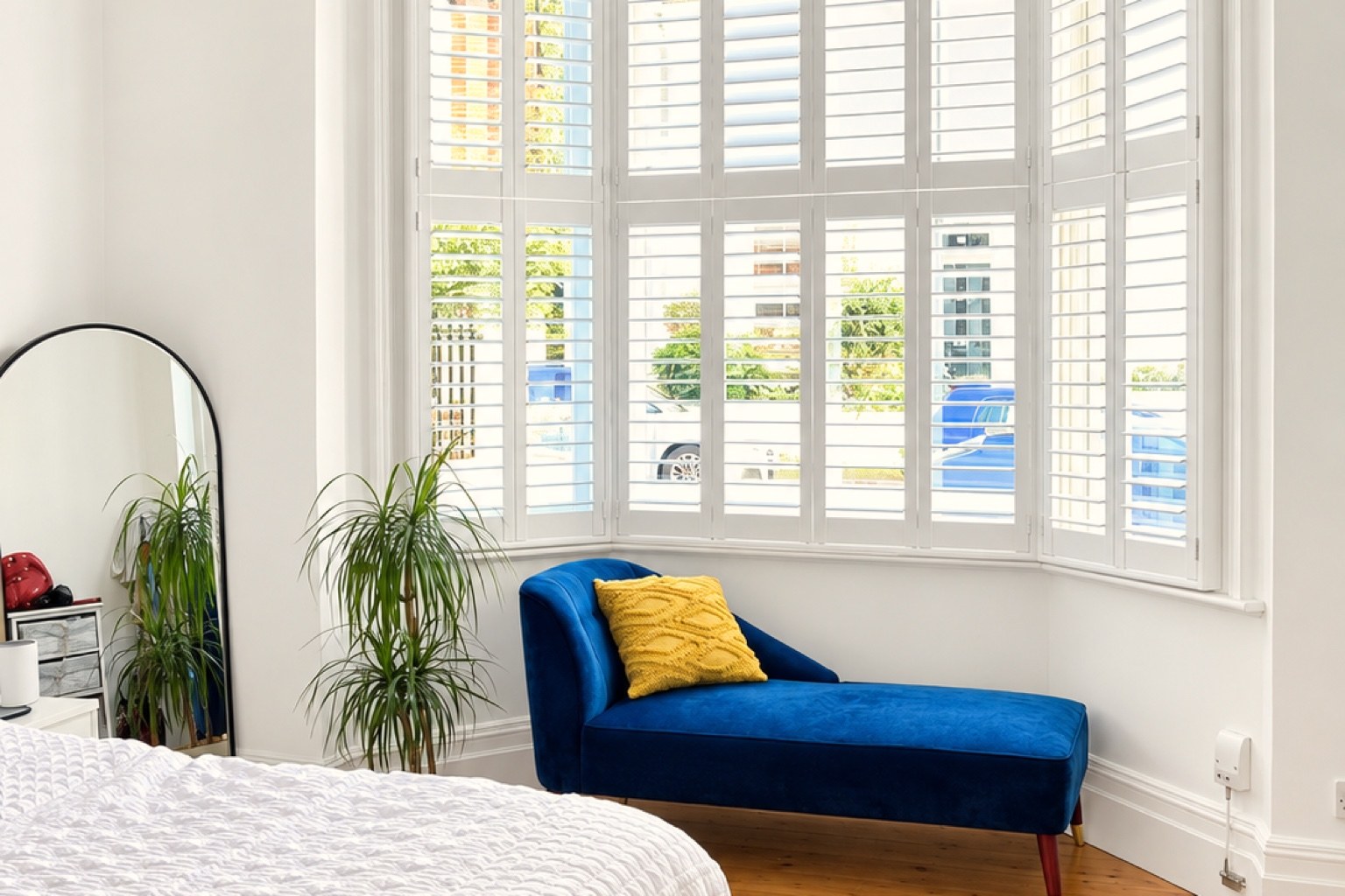 Cuba basswood shutters fitted across a bright bay window