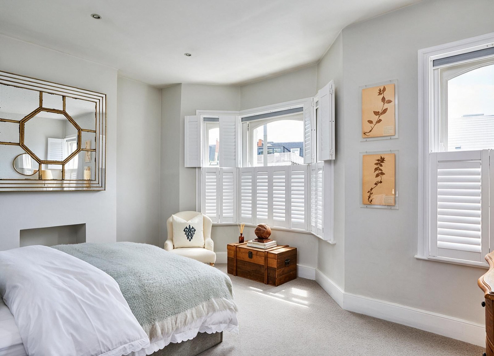 Tier on tier shutters fitted around a bedroom bay window