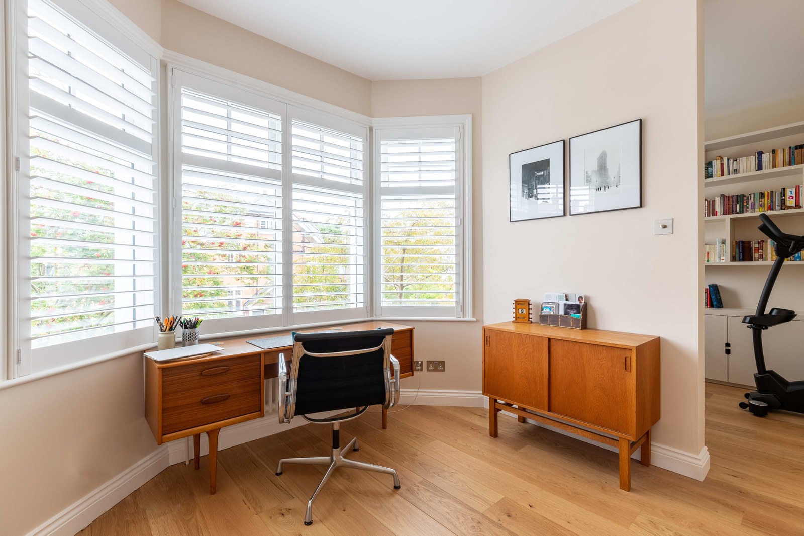 Cuba hardwood shutters fitted around a bay window in a home office