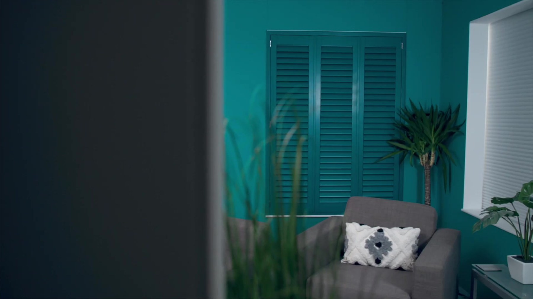 Teal Java waterproof shutters in a bright room