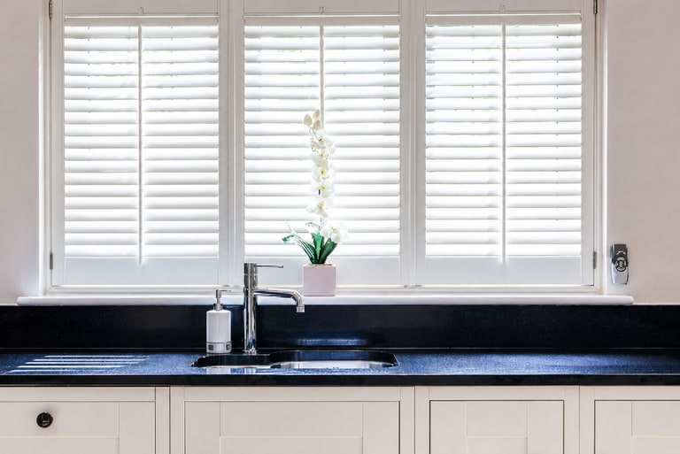 Full height shutters in a bright kitchen