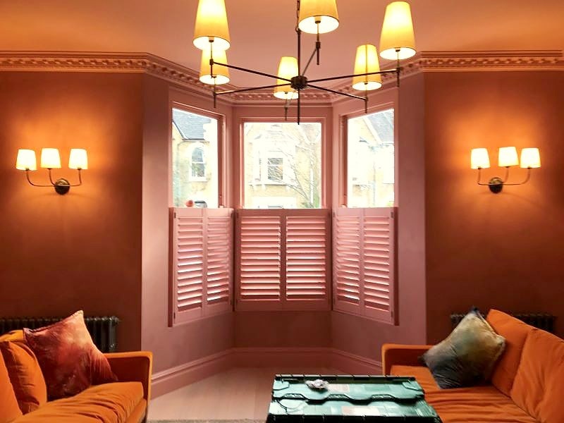 Custom-colour café-style shutters fitted to an Islington bay window