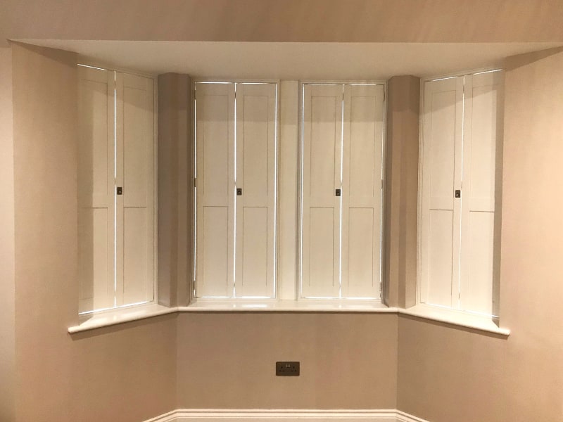 Close up of a Solid Shaker shutter installation on a bay window