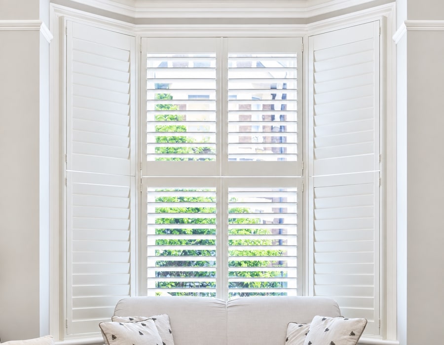 White shutters fitted around a bay window
