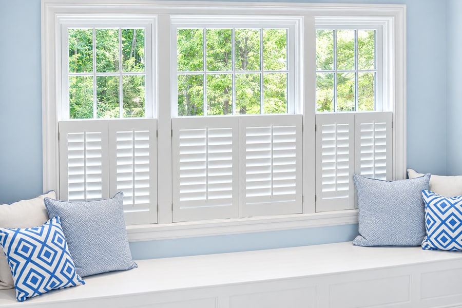 White café style shutters above a window seat