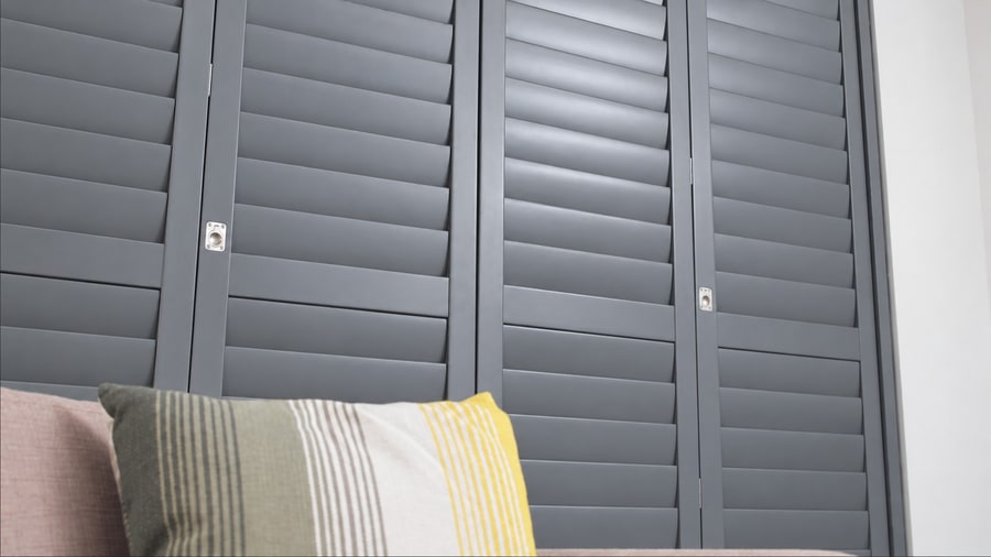 Grey Cuba shutters with a sofa